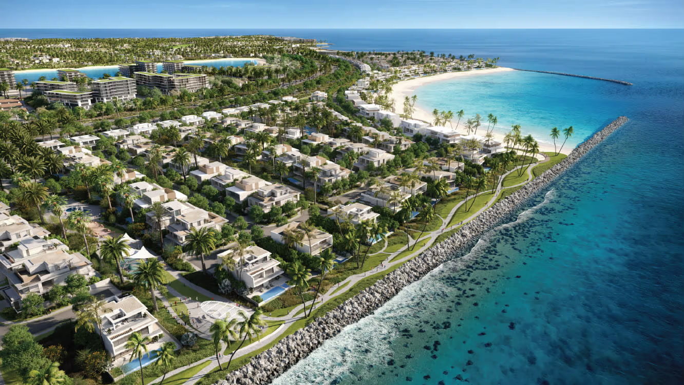 Luxury coastal residential development in the UAE — white villas, palm trees and turquoise Arabian Sea water, aerial view